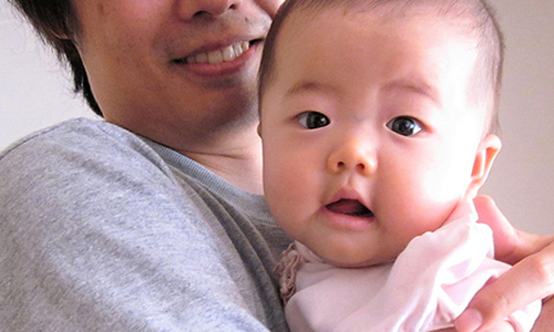 Photo of a man holding a child